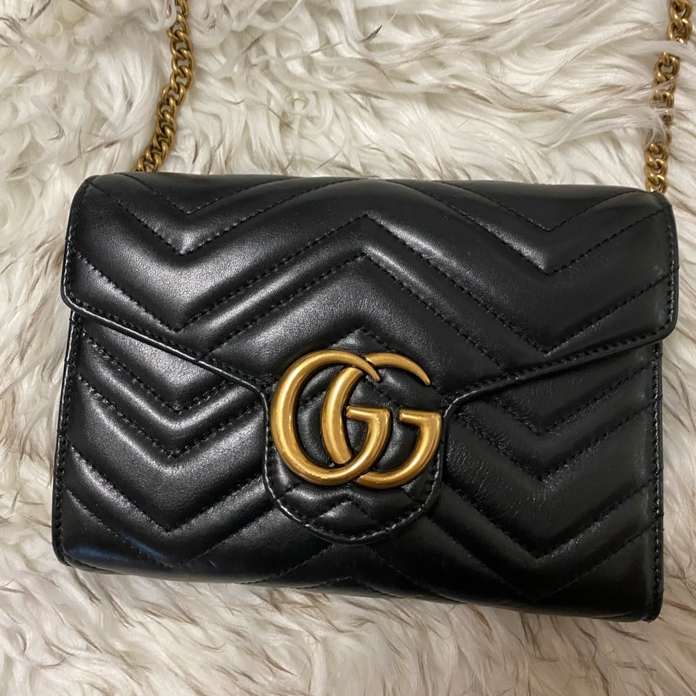 Black Gucci Marmot bag with wallet features